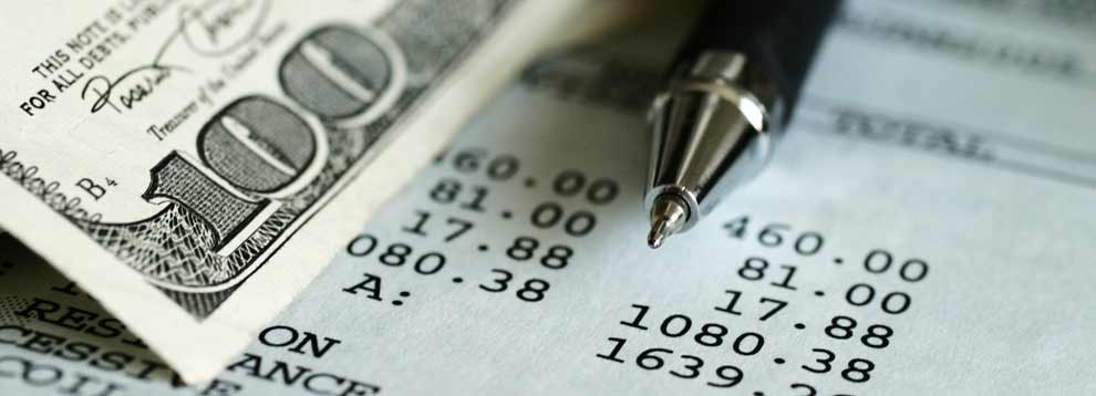 accounting-ledger-100-dollar-bill-990x358