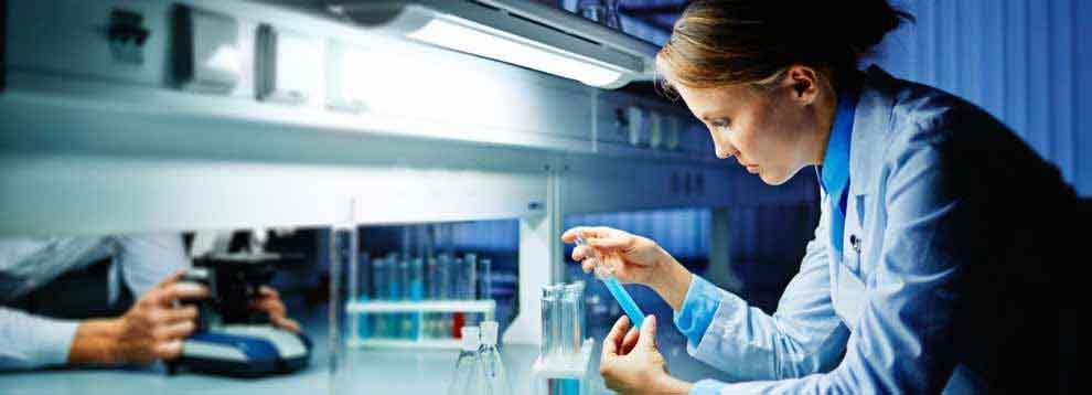 lab-technician-studying-vial-990x358