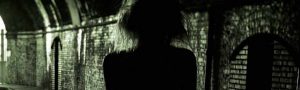 silhouette of woman in tunnel