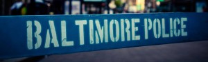 baltimore police department's name on white on a blue barricade