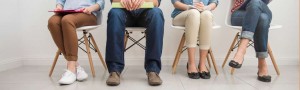 four seated individuals with different body language