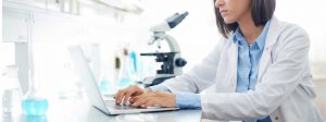scientist on laptop in lab