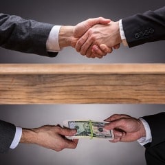 https://www.forensicscolleges.com/wp-content/uploads/2018/12/businesspeople-shaking-hands-and-taking-bribe-under-table-picture-id928085588-1-min.jpg