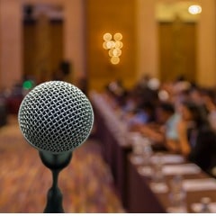 https://www.forensicscolleges.com/wp-content/uploads/2019/01/microphone-over-the-abstract-blurred-photo-of-conference-hall-or-picture-id825187104-min.jpg