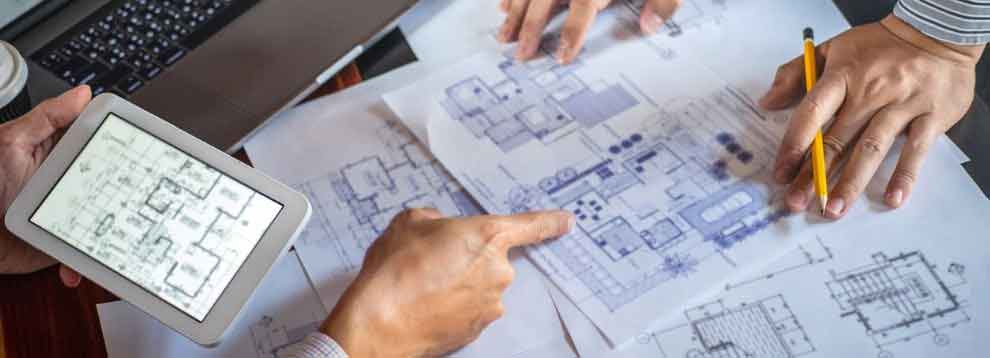 construction-engineering-or-architect-discuss-a-blueprint-while-on-picture-id1154804646-min